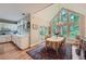 Dining area with vaulted ceiling, bright windows, hardwood floors, and a decorative rug at 8470 Valemont Dr, Atlanta, GA 30350