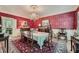 Elegant dining room with ornate chandelier, and dark red wallpaper, perfect for entertaining at 8470 Valemont Dr, Atlanta, GA 30350