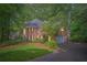 Elegant brick home featuring an attached garage, lush landscaping, and a pristine lawn at 8470 Valemont Dr, Atlanta, GA 30350