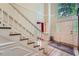 Grand foyer with hardwood floors, staircase, and large windows creating a bright entrance at 8470 Valemont Dr, Atlanta, GA 30350
