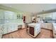 Traditional kitchen with white cabinets, an island with wine storage, and hardwood floors at 8470 Valemont Dr, Atlanta, GA 30350
