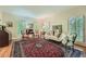 Elegant living room with hardwood floors, large rug, and natural light from shuttered windows at 8470 Valemont Dr, Atlanta, GA 30350