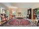 Elegant living room with hardwood floors, large rug, and natural light from shuttered windows at 8470 Valemont Dr, Atlanta, GA 30350