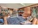 Living room boasts wood paneling, fireplace, hardwood floors, and built-in bookshelves at 8470 Valemont Dr, Atlanta, GA 30350