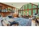 Formal living room featuring wood paneling, a fireplace, and large windows with wooded views at 8470 Valemont Dr, Atlanta, GA 30350