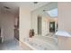 Relaxing main bathroom showcasing a jacuzzi tub and a skylight at 8470 Valemont Dr, Atlanta, GA 30350