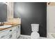 Charming bathroom with a dark accent wall, unique floor tiles, and a beautifully crafted vanity at 143 Frances Dr, Dallas, GA 30157