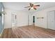 Bright bedroom with hardwood floors, ceiling fan, and closet space with an ensuite bathroom at 143 Frances Dr, Dallas, GA 30157