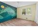 Bedroom with a modern mural, natural light, and hardwood floors at 143 Frances Dr, Dallas, GA 30157