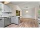 Modern kitchen featuring stainless steel appliances, stone countertops, and new floors with natural light at 143 Frances Dr, Dallas, GA 30157
