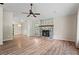 Living room featuring wood floors, fireplace, natural light, and open floor plan at 143 Frances Dr, Dallas, GA 30157