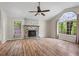 Bright living room boasting wood floors, a fireplace, and a large arched window at 143 Frances Dr, Dallas, GA 30157