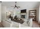 Cozy living room with a brick fireplace, ceiling fan, and open floor plan to dining area at 143 Frances Dr, Dallas, GA 30157