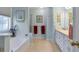 Bright bathroom with soaking tub, walk-in shower, and vanity with white cabinets and beige countertop at 239 Taylors Farm Drive Dr, Canton, GA 30115