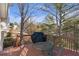 Relaxing outdoor deck space with mature trees, space for grilling, and table setting for entertaining at 239 Taylors Farm Drive Dr, Canton, GA 30115