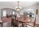 Spacious dining room with views of the kitchen and living room, featuring hardwood floors and natural light at 239 Taylors Farm Drive Dr, Canton, GA 30115