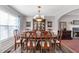 Elegant dining room featuring a wooden table, upholstered chairs, hardwood floors and a decorative chandelier at 239 Taylors Farm Drive Dr, Canton, GA 30115