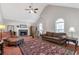 Spacious living room with vaulted ceilings, natural light from arched windows and cozy fireplace feature at 239 Taylors Farm Drive Dr, Canton, GA 30115