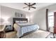 Comfortable main bedroom with ceiling fan, natural light, and plush bedding at 239 Taylors Farm Drive Dr, Canton, GA 30115