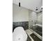 Modern bathroom featuring a walk-in shower, soaking tub, stone accents and black matte hardware at 244 Coastline Road Rd, Fayetteville, GA 30214