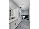 Modern bathroom featuring granite countertops, white cabinetry, soaking tub, and stylish light fixtures at 244 Coastline Road Rd, Fayetteville, GA 30214