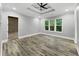 Elegant bedroom with hardwood floors, recessed lighting, tray ceiling and a view of the living area at 244 Coastline Road Rd, Fayetteville, GA 30214