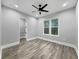Bedroom with wood-style floors, ceiling fan, and natural light from the windows and a walk-in closet at 244 Coastline Road Rd, Fayetteville, GA 30214