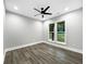 Bedroom with wood-style floors, ceiling fan, and natural light from the windows at 244 Coastline Road Rd, Fayetteville, GA 30214