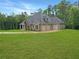 Beautiful home with a three-car garage, lush lawn, and mature trees at 244 Coastline Road Rd, Fayetteville, GA 30214