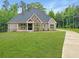 Charming single-story home with a brick and stone facade, large windows, and a well-manicured lawn at 244 Coastline Road Rd, Fayetteville, GA 30214