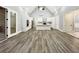 Open floor plan with hardwood floors, vaulted ceilings, white cabinets and a large island with a sink at 244 Coastline Road Rd, Fayetteville, GA 30214