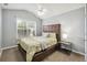 Bedroom featuring a window that lets in natural light, a ceiling fan, and neutral décor at 11529 Vinea Ln, Hampton, GA 30228