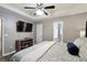 Inviting bedroom with an electric fireplace and tv, plus an ensuite bath at 11529 Vinea Ln, Hampton, GA 30228