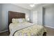 Bedroom featuring a decorative ceiling fan and natural light with neutral decor at 11529 Vinea Ln, Hampton, GA 30228