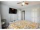 Bedroom showcasing a ceiling fan, mounted TV, and a comfortable bed with stylish bedding at 11529 Vinea Ln, Hampton, GA 30228