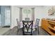 Charming dining area with a table set for four and a storage cabinet at 11529 Vinea Ln, Hampton, GA 30228