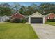 Charming single-story home with brick and siding, a well-manicured lawn, and an attached two-car garage at 11529 Vinea Ln, Hampton, GA 30228