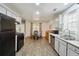 Traditional kitchen with stainless steel appliances, painted cabinets and a dining table area at 11529 Vinea Ln, Hampton, GA 30228