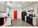 Modern kitchen features stainless steel appliances and a bright red accent door at 11529 Vinea Ln, Hampton, GA 30228