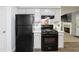 Traditional kitchen featuring black appliances, painted cabinets, and sleek countertops at 11529 Vinea Ln, Hampton, GA 30228
