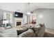 Bright living room featuring a fireplace, ceiling fan, and comfortable seating, with neutral paint and carpet at 11529 Vinea Ln, Hampton, GA 30228