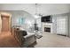Cozy living room with a fireplace, ceiling fan, and a comfortable couch at 11529 Vinea Ln, Hampton, GA 30228
