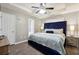 Spacious main bedroom featuring a tray ceiling, updated flooring and a cozy bed at 11529 Vinea Ln, Hampton, GA 30228