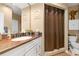 Bathroom vanity with decorative elements and a shower with a patterned curtain at 220 Renaissance Ne Pkwy # 1115, Atlanta, GA 30308