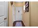 Hallway with dark wood floors, neutral walls, and white doors adding to the space's elegance at 220 Renaissance Ne Pkwy # 1115, Atlanta, GA 30308