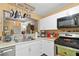 Well-lit kitchen boasts white cabinets, modern appliances, and open layout to the dining area at 220 Renaissance Ne Pkwy # 1115, Atlanta, GA 30308