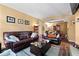 Spacious living room with comfortable leather seating and open access to the dining area and fireplace at 220 Renaissance Ne Pkwy # 1115, Atlanta, GA 30308