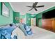 Cozy main bedroom features green walls, comfortable bed, and a ceiling fan at 220 Renaissance Ne Pkwy # 1115, Atlanta, GA 30308