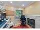 Cozy office featuring a fireplace, comfortable chair, and a view of the outdoors through the window at 220 Renaissance Ne Pkwy # 1115, Atlanta, GA 30308