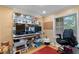Functional office space with built-in shelving, ample desk space, and natural light from the window at 220 Renaissance Ne Pkwy # 1115, Atlanta, GA 30308